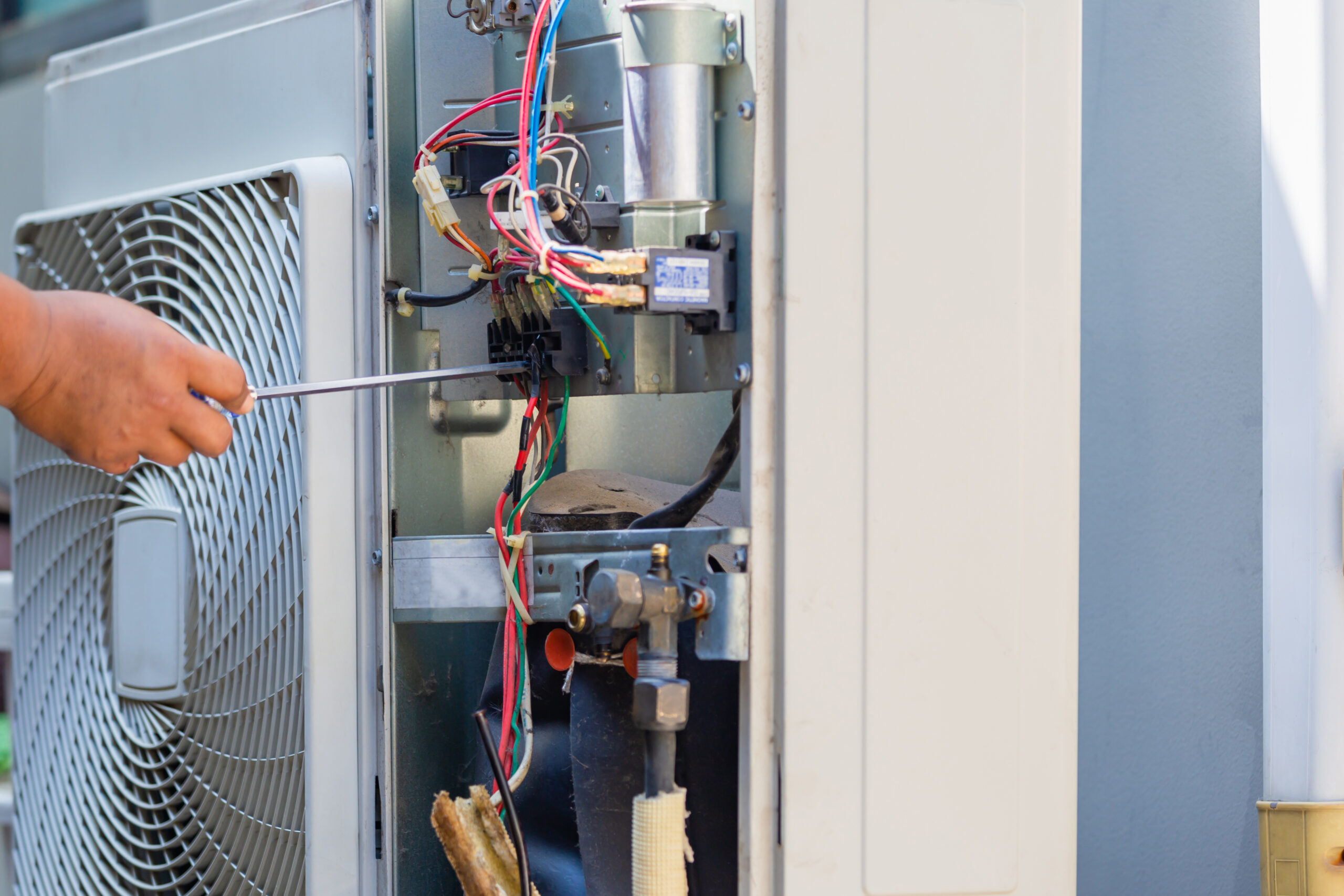 Male,Technician,Hands,Using,A,Screwdriver,Fixing,Modern,Air,Conditioner,