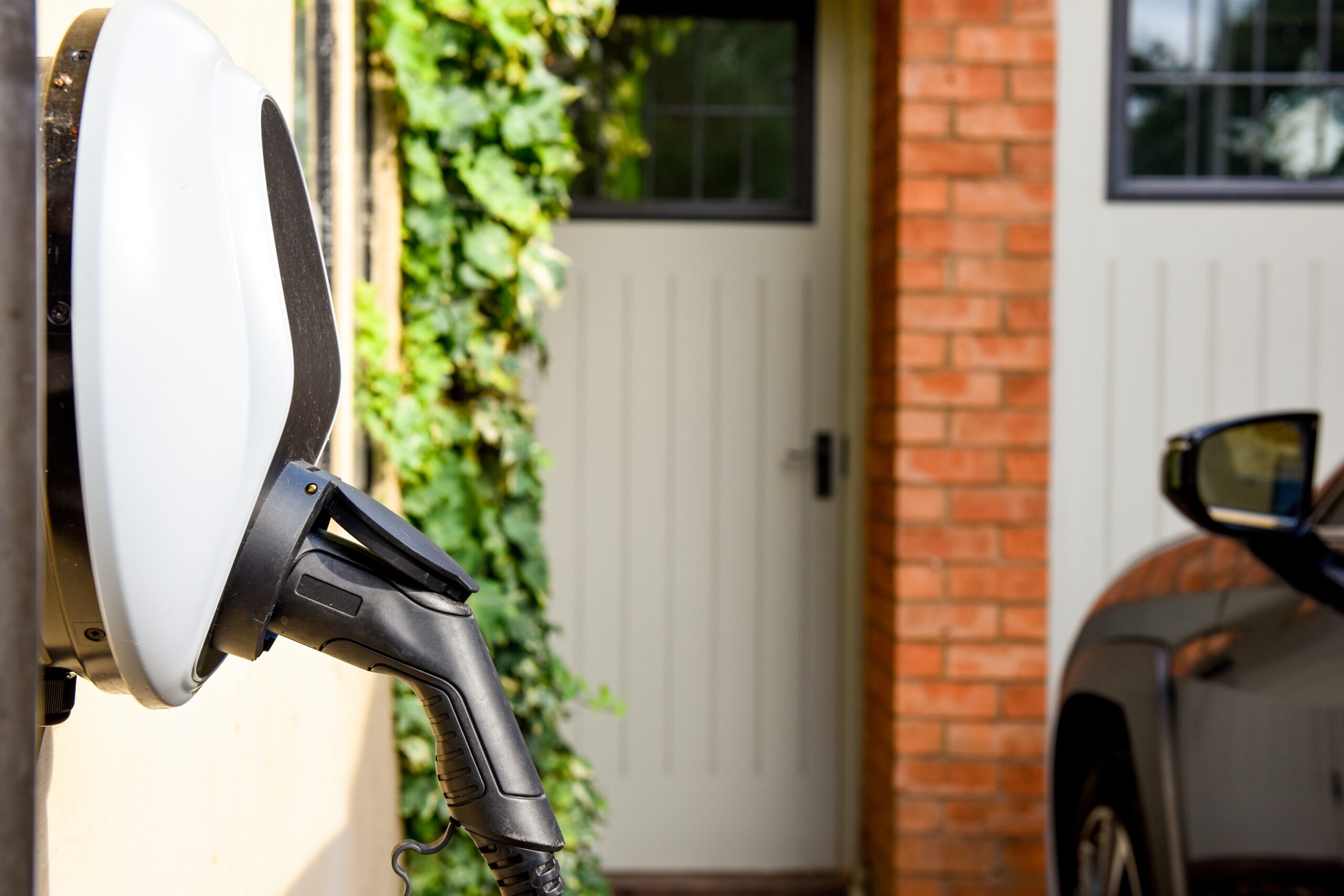 Electric,Car,Plugged,In,To,Charge,Outside,Home,With,Power